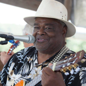 photo of Danny Cox playing an acoustic guitar at the KCK Street Blues Festival in 2018