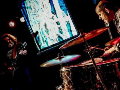 ElectroBluesSociety in concert, a man playing guitar and a man playing drums