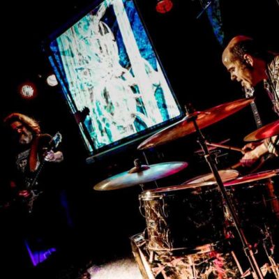 ElectroBluesSociety in concert, a man playing guitar and a man playing drums