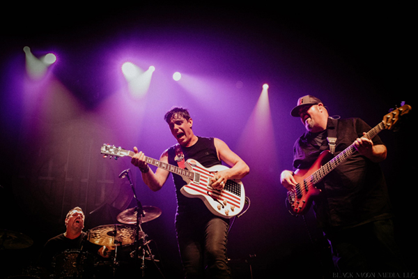 Nick Schnebelen playing guitar with his band