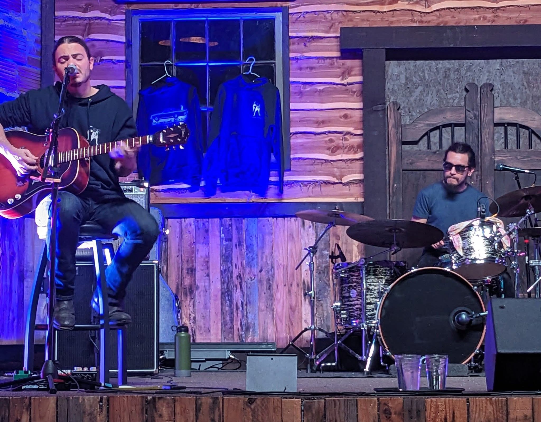 Howard Mahan performing with acoustic guitar. 